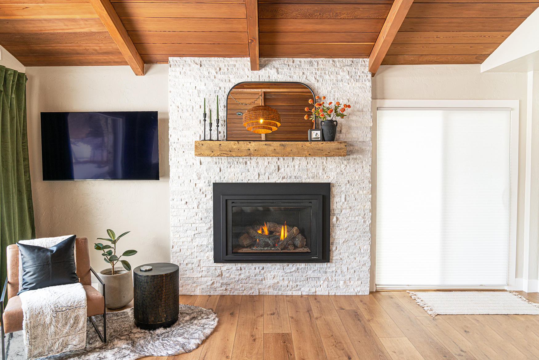 White marble stacked stone fireplace with recycled barn wood beam mantle and modern organic home decor