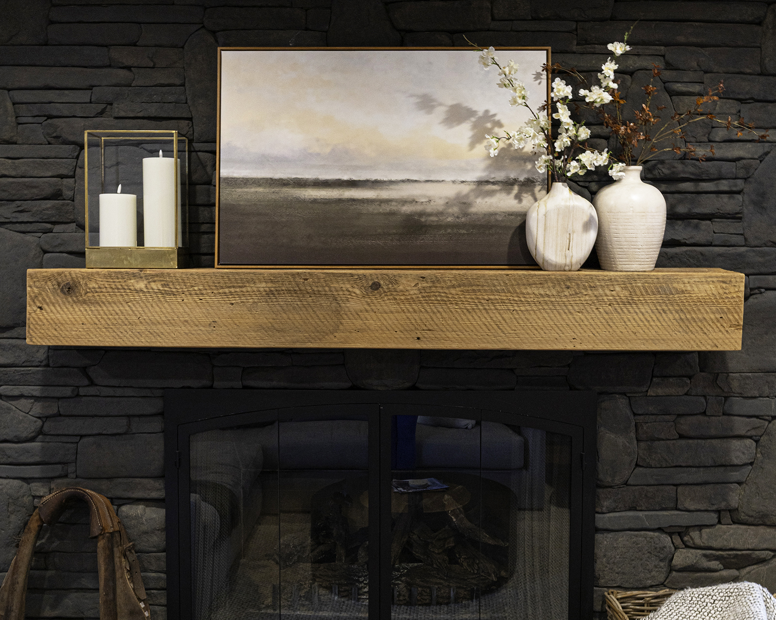 Dark grey wash painted stone fireplace styled for spring