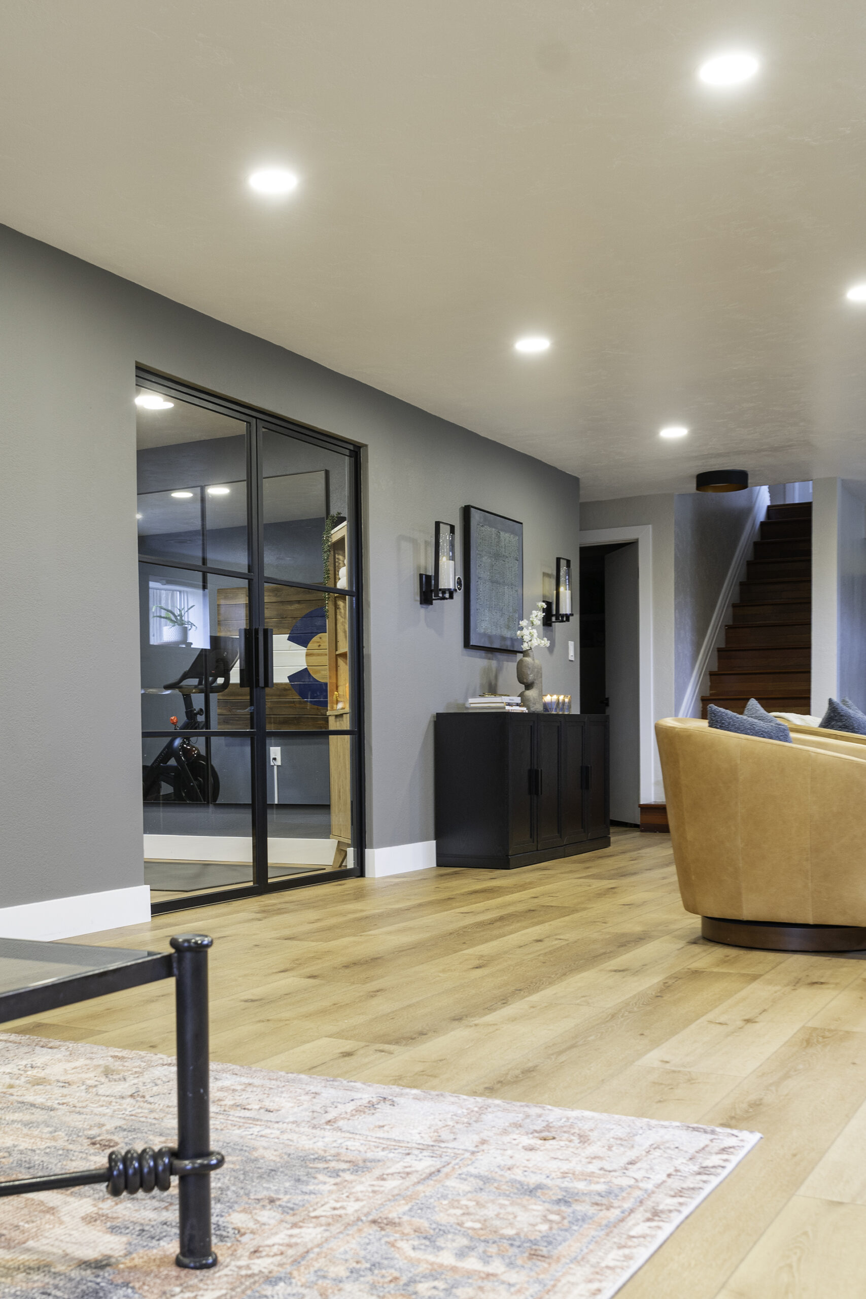 styled basement entry with home gym 