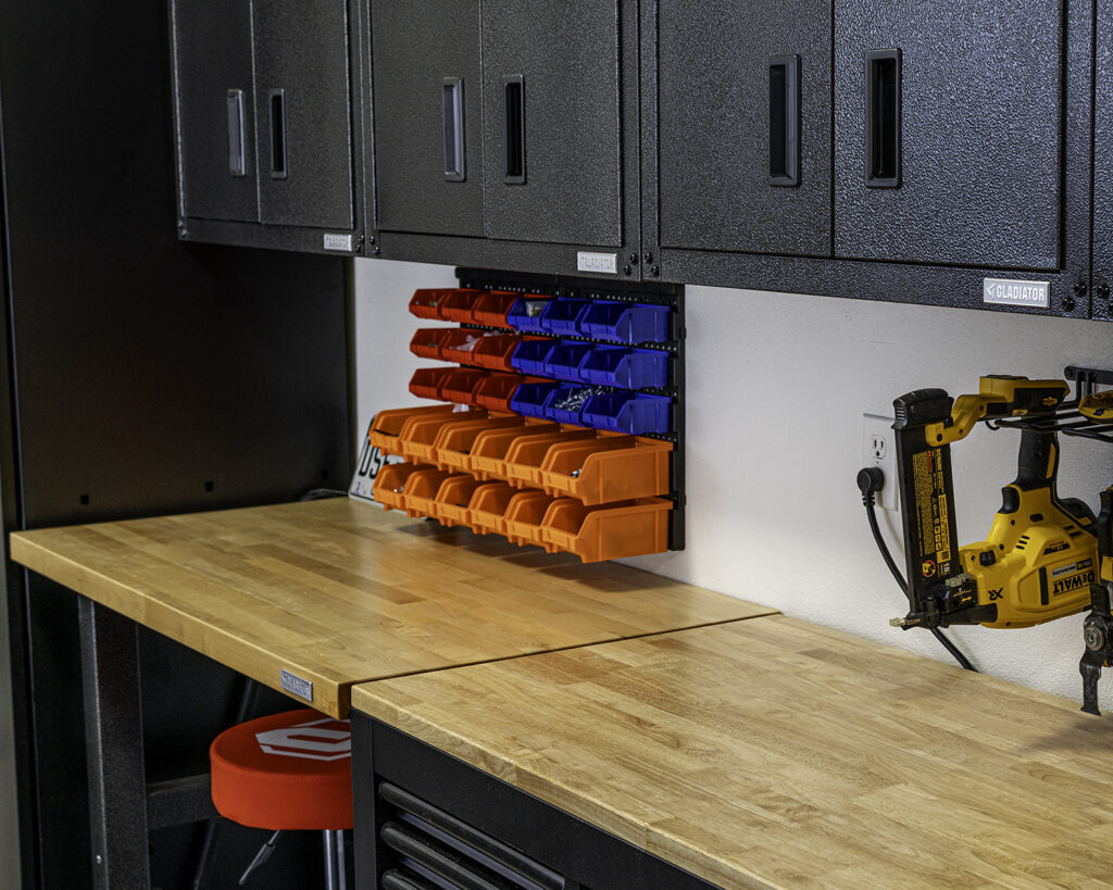 Organized garage makeover with steel cabinets, workbench, work table and tall storage cabinet